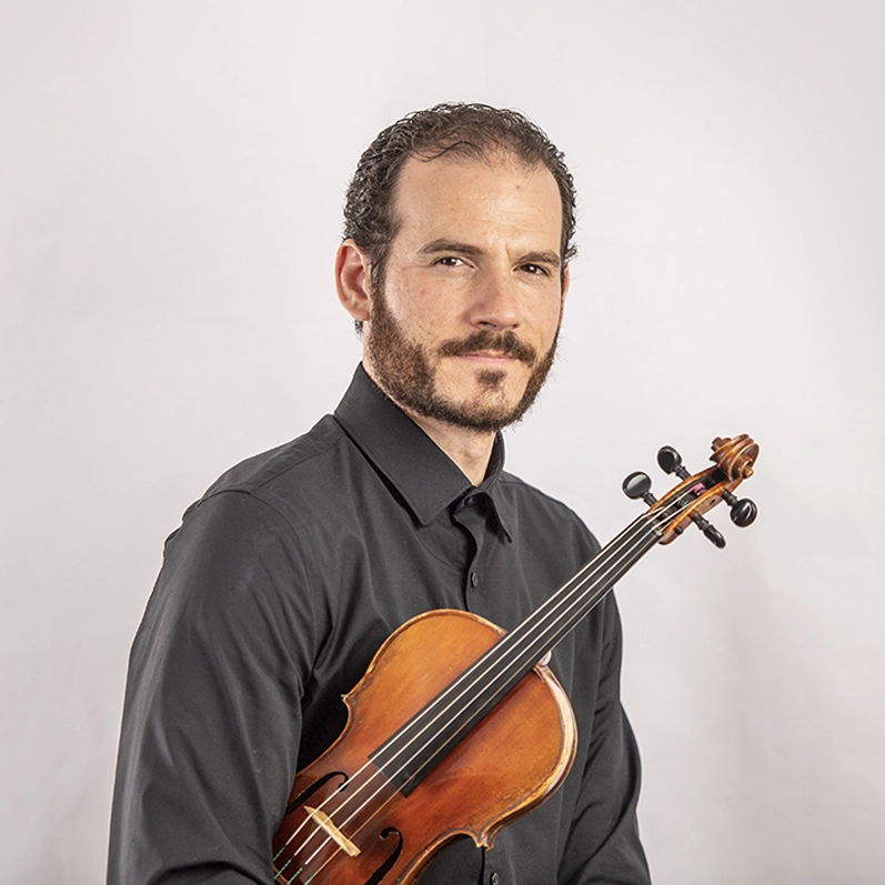 Violinist Johnathan Spence holding his violin
