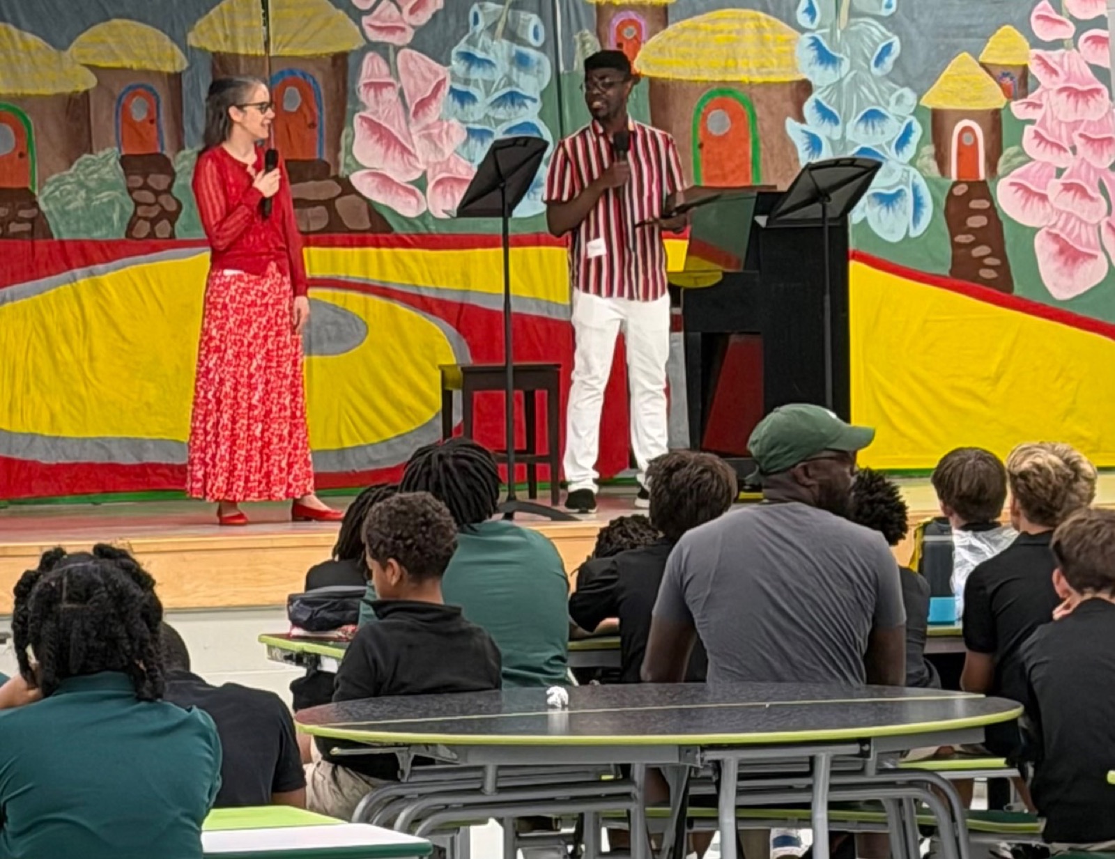Students attending an interactive school performance in a cafeteria