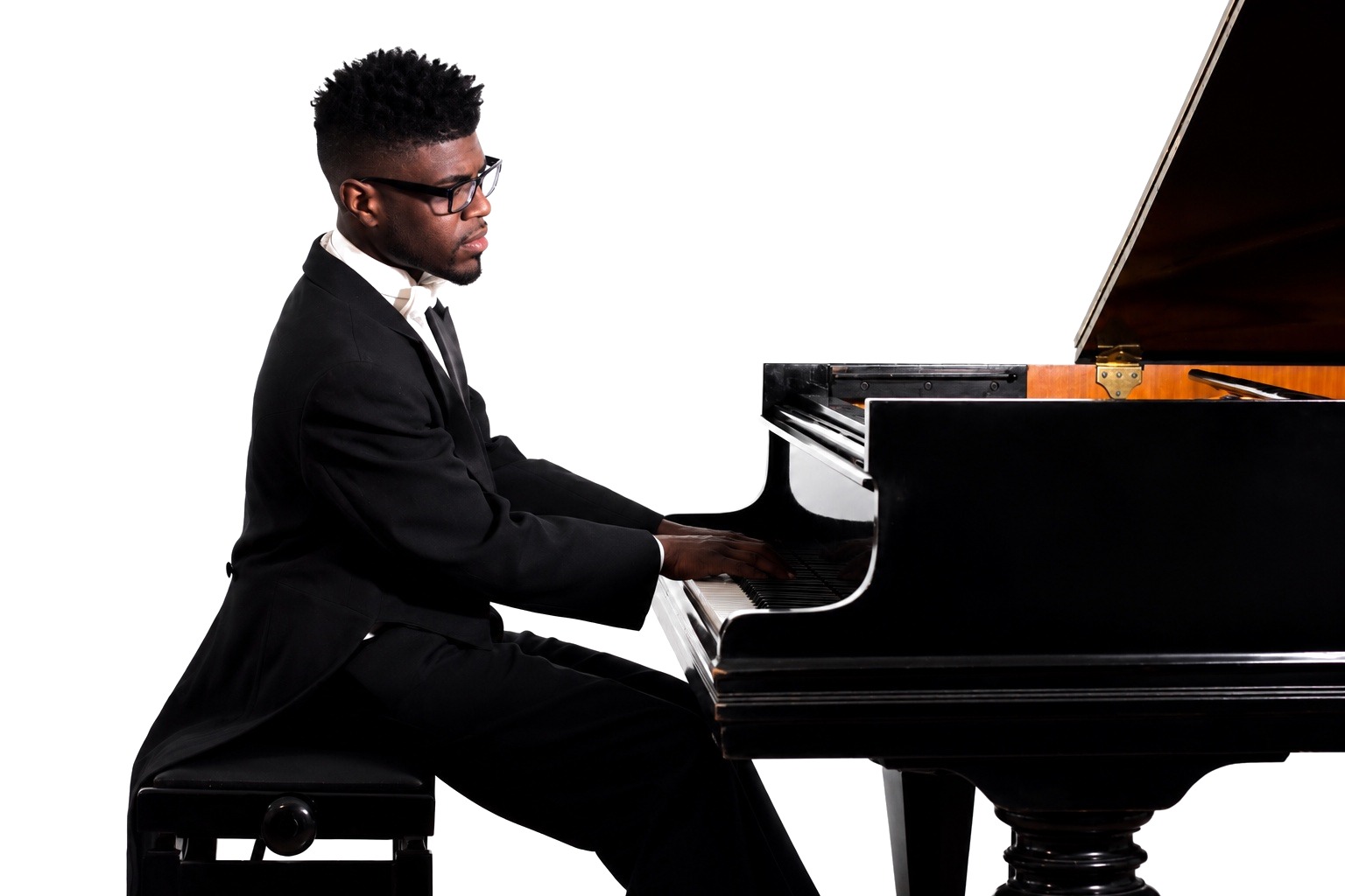 Kyle P. Walker performing at a grand piano