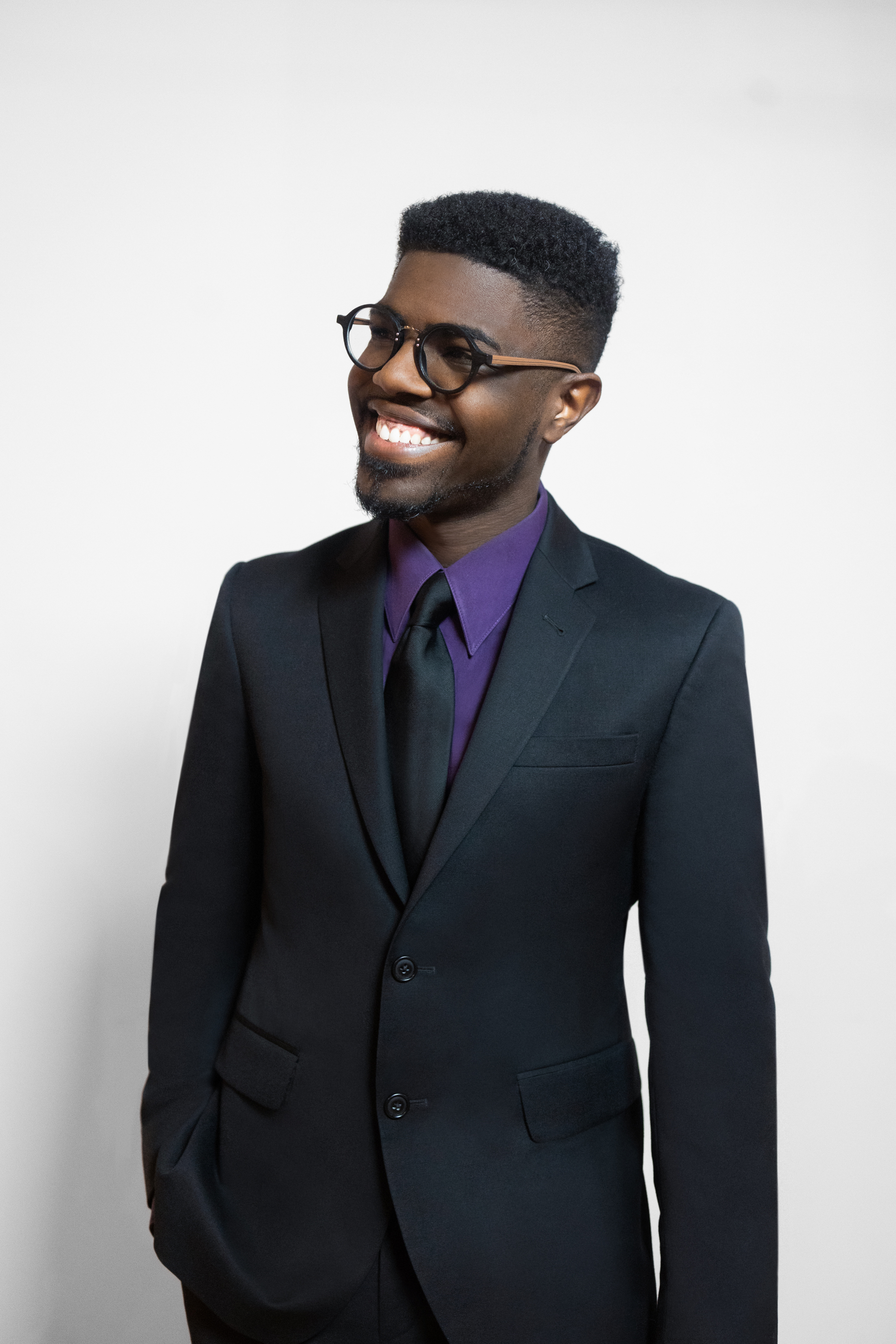 Kyle P. Walker smiling in a studio portrait